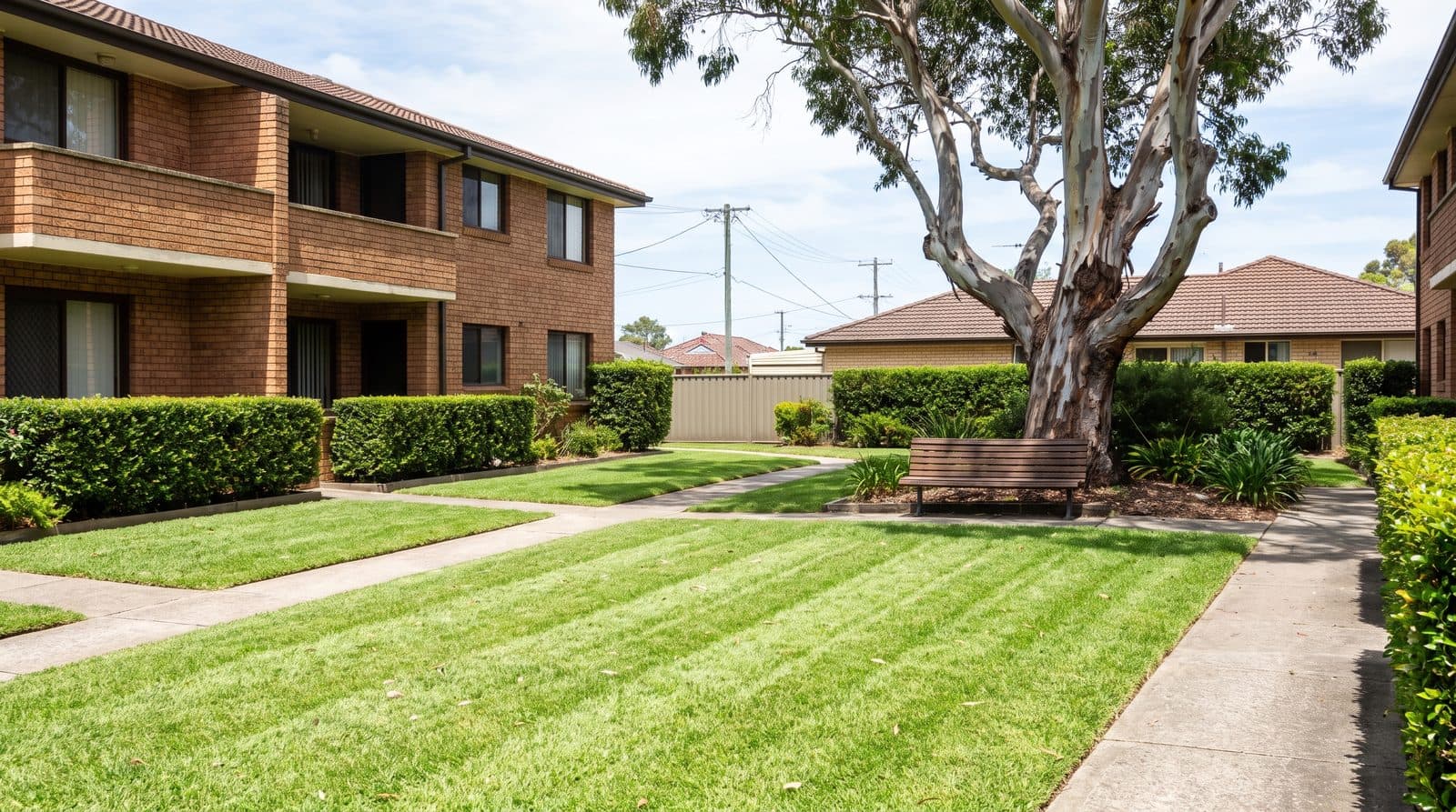 Mowed common lawn of a low-rise strata complex
